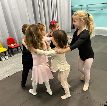 Young dancers in a circle during class